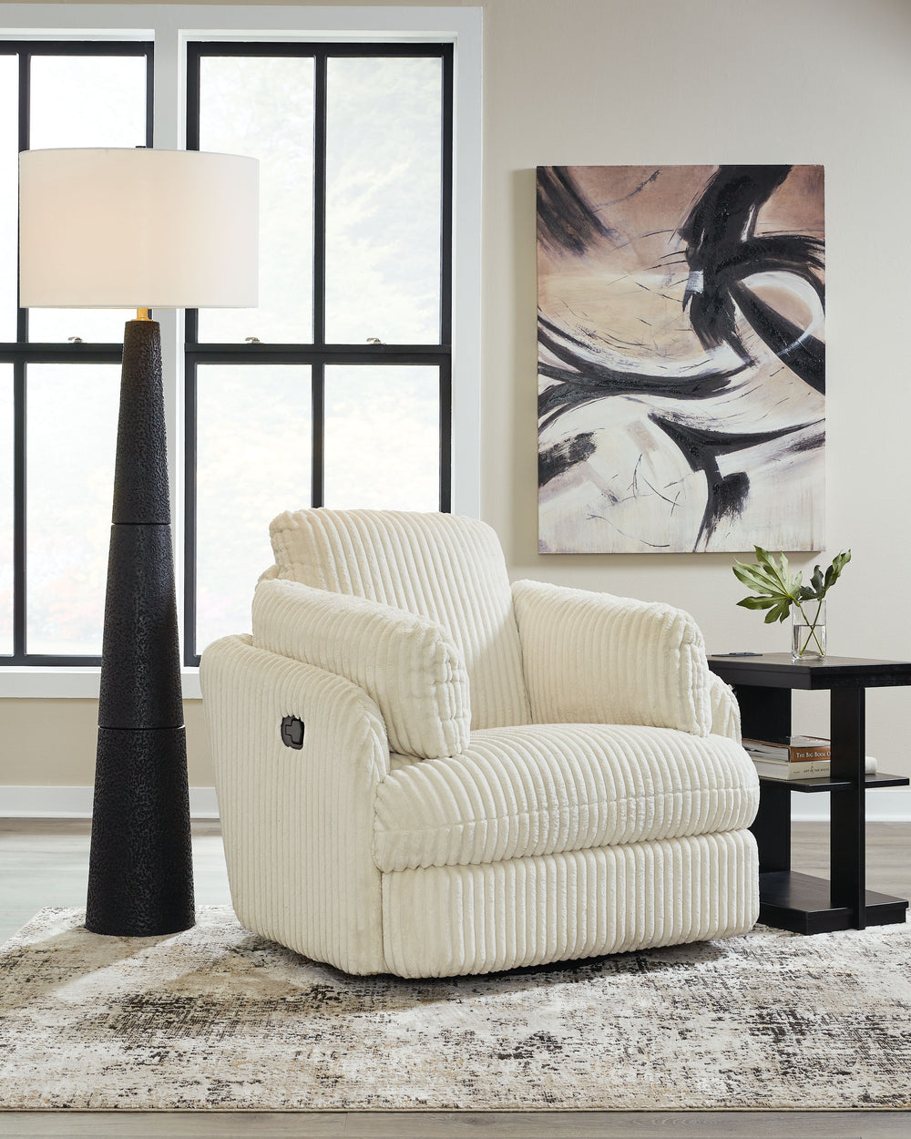 Like a warm hug, this recliner envelops you in comfort with its barrel shape and soft cord upholstery. It reclines, glides, and swivels to cater to your every need. This chair also features posh bolster pillows and cleverly designed storage. Unwind and cu
