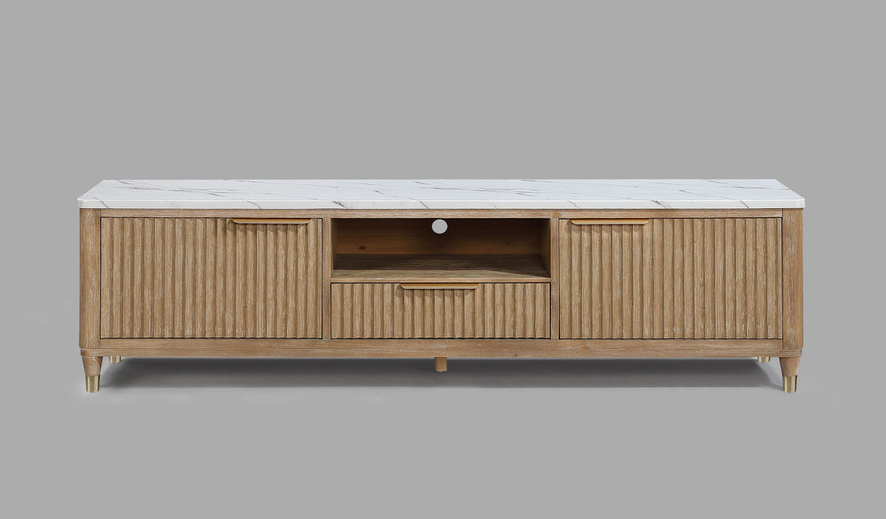 This entertainment console brings modern luxury and sleek sophistication to any living space. Featuring a fluted wood facade with a pristine white faux marble top, this piece embodies refined elegance. Brass-tone accents and tapered legs add a touch of mi