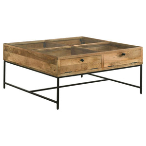 Bring farmhouse charm to your living room with this shadowbox coffee table. A tempered glass top offers a clear view of treasures stored in four compartments, accessed by drop-front doors with chain suspension for a unique touch. Crafted from solid mango 