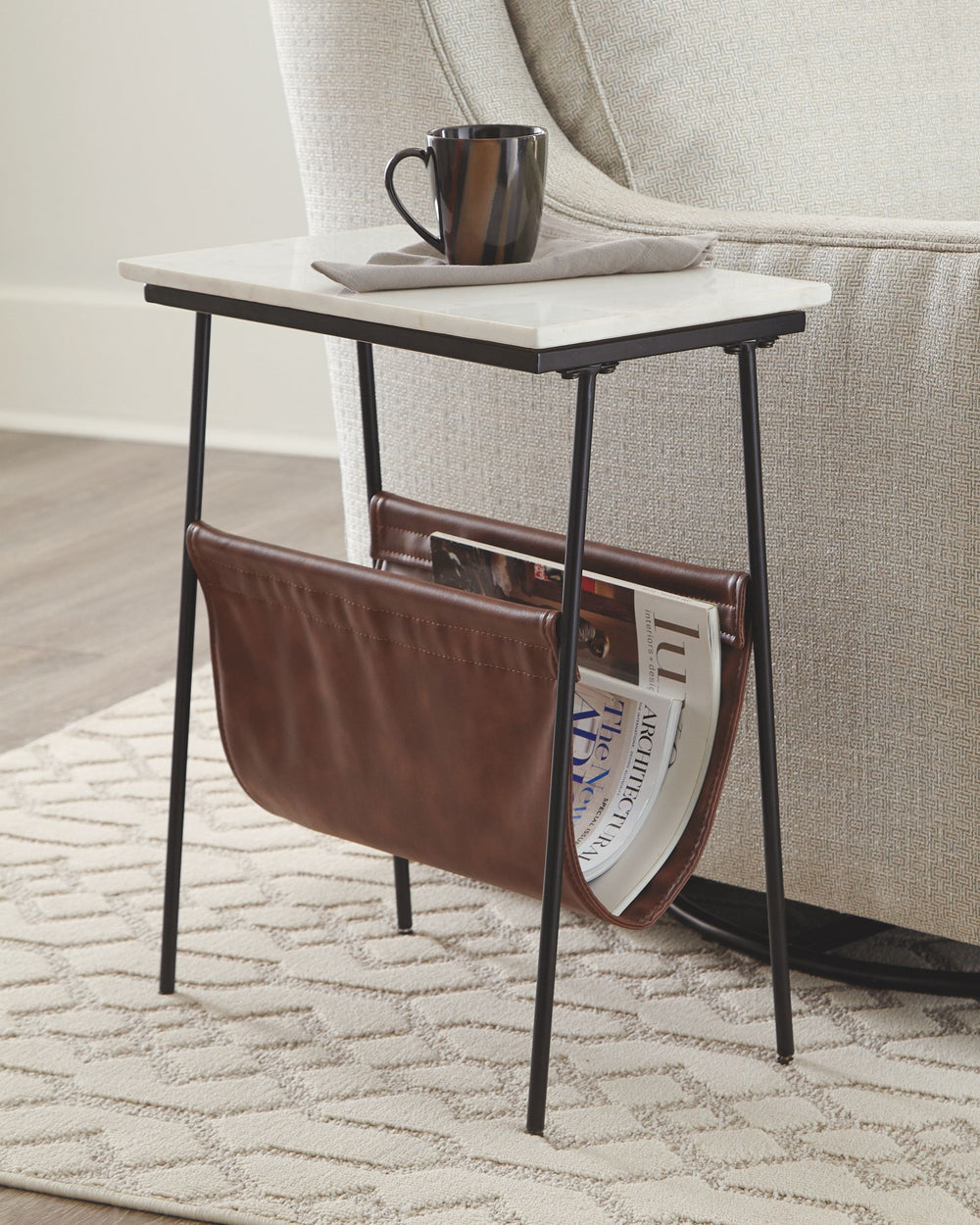 With its mixed media design, this accent table with magazine holder is whatâ€™s newâ€”and whatâ€™s you. A fusion of black metal, white marble and brown faux leather creates a contemporary aesthetic thatâ€™s the genuine article.<br><br><b>Additional Dimens