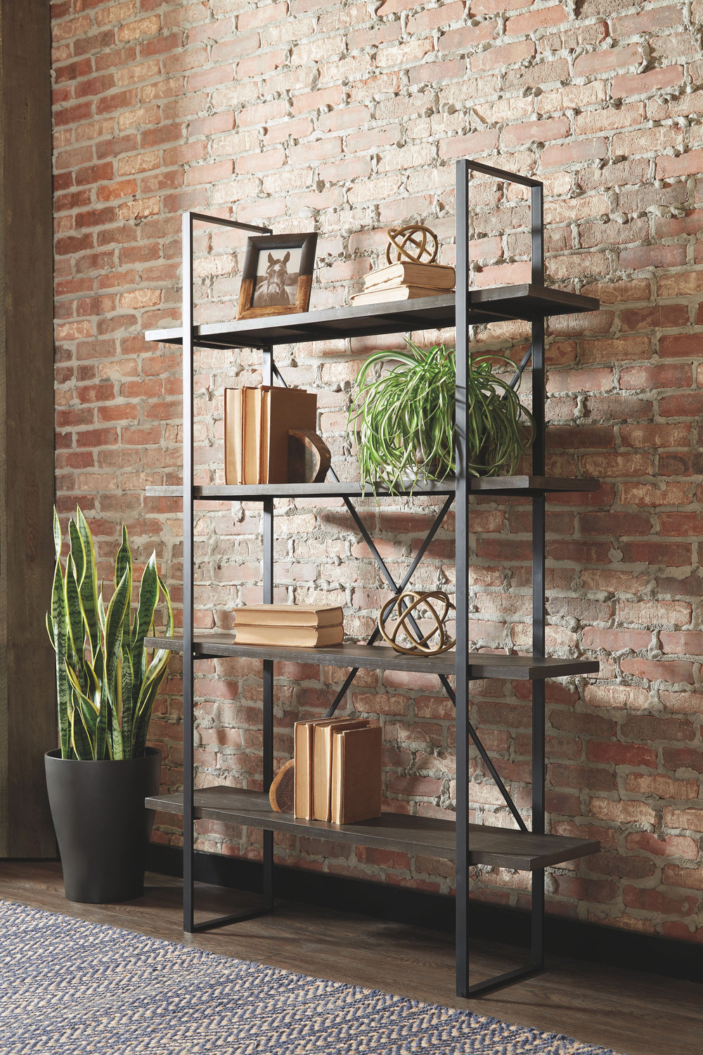 Got books? Bring them to this bookcase. Its industrial mix of dark wood and black metal brings trendsetting vibes to your home. Four sturdy shelves hold your belongings with ease. Mix in some metallic decor for a home office look you canâ€™t refuse.<br><b