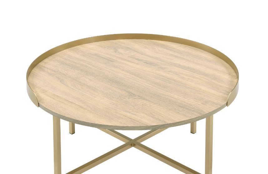 Explore modern simplicity that easily improve your overall aesthetic. The Mithea Coffee Table features a round table top with cross bar styled metal base, offering a balance of grace and strength. An alluring gold finish showcases it-'s clean-lined silhou