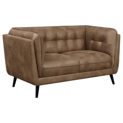 Complete your contemporary living room setup with this mid-century modern shelter style loveseat, designed as an updated take on the classic Chesterfield style silhouette including grid tufted seats and backs along with welt trim details. Upholstered in a