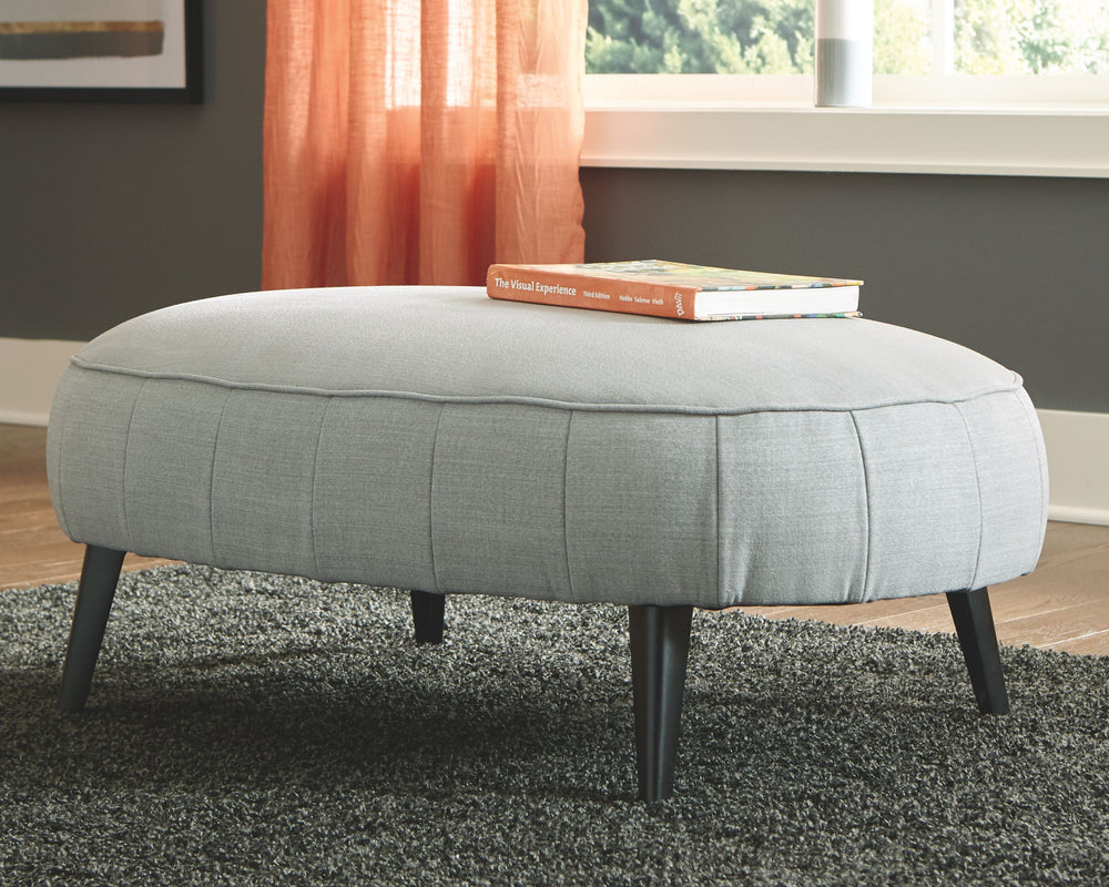 Cool takes a new shape in your living room with this ottoman. Rounding out your stylish, urban space, this piece sports a velvety soft upholstery and sleek, tapered legs. Pop your feet up or use this oversized accent as a center table with a tray placed o