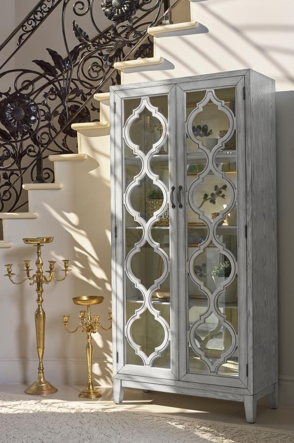 Showcase your cherished items in this striking display cabinet, crafted with intricate lattice wood overlay and mirrored back panels for added depth and elegance. Framed glass doors open to reveal three shelves ideal for displaying collectibles or dinnerw