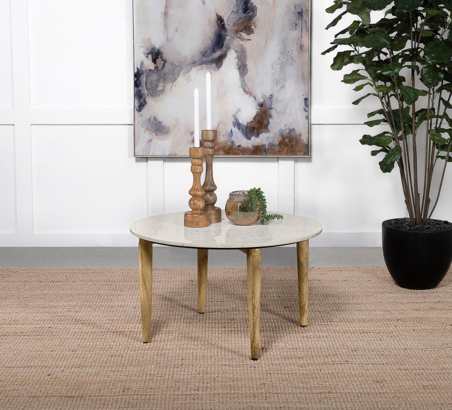 A low-key yet elegant look starts with a hand-crafted round coffee table with earthy tones and plenty of versatility. Choose this coffee table to round out a space with a natural design aesthetic and add a fluid look to a living room or family room. Made 