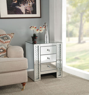 The Nysa mirrored occasional table demonstrates sophisticated, graceful and elegant, style with unique design. This table features three storage drawers decorative drawer pull knobs. While elegantly reflecting its surroundings, combines glamour with moder