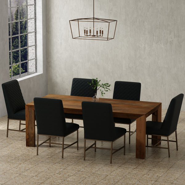 Crafted from solid mango, this table boasts a unique aesthetic with natural variations of color, wood grain, and knots. The geometric mitered edge creates a seamless transition between the table top, apron, and angled legs, and is generously proportioned 