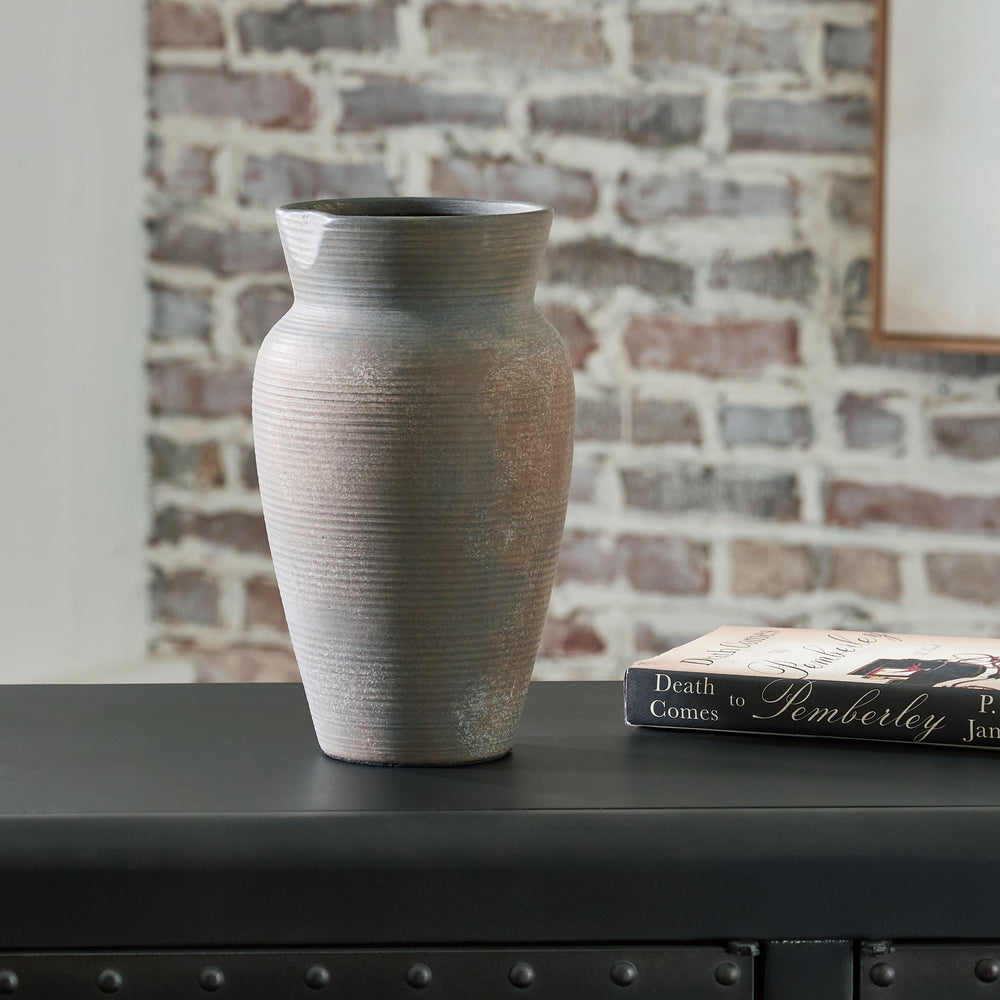 Contain your enthusiasm for casual earthy elegance. Loaded with a sense of antiqued beauty, this stunning ceramic vase adds a beautiful timeworn quality to your home. Let it wow on its own, or kick things up a notch and fill it with faux or dried bouquets