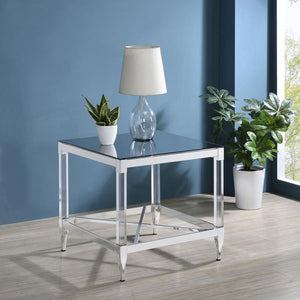  this end table is a masterpiece of reflective beauty and modern design. The mirrored tempered glass top offers a dynamic surface that reflects light and life around it. Clear acrylic leg posts provide a sense of