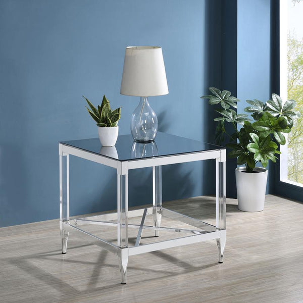  this end table is a masterpiece of reflective beauty and modern design. The mirrored tempered glass top offers a dynamic surface that reflects light and life around it. Clear acrylic leg posts provide a sense of