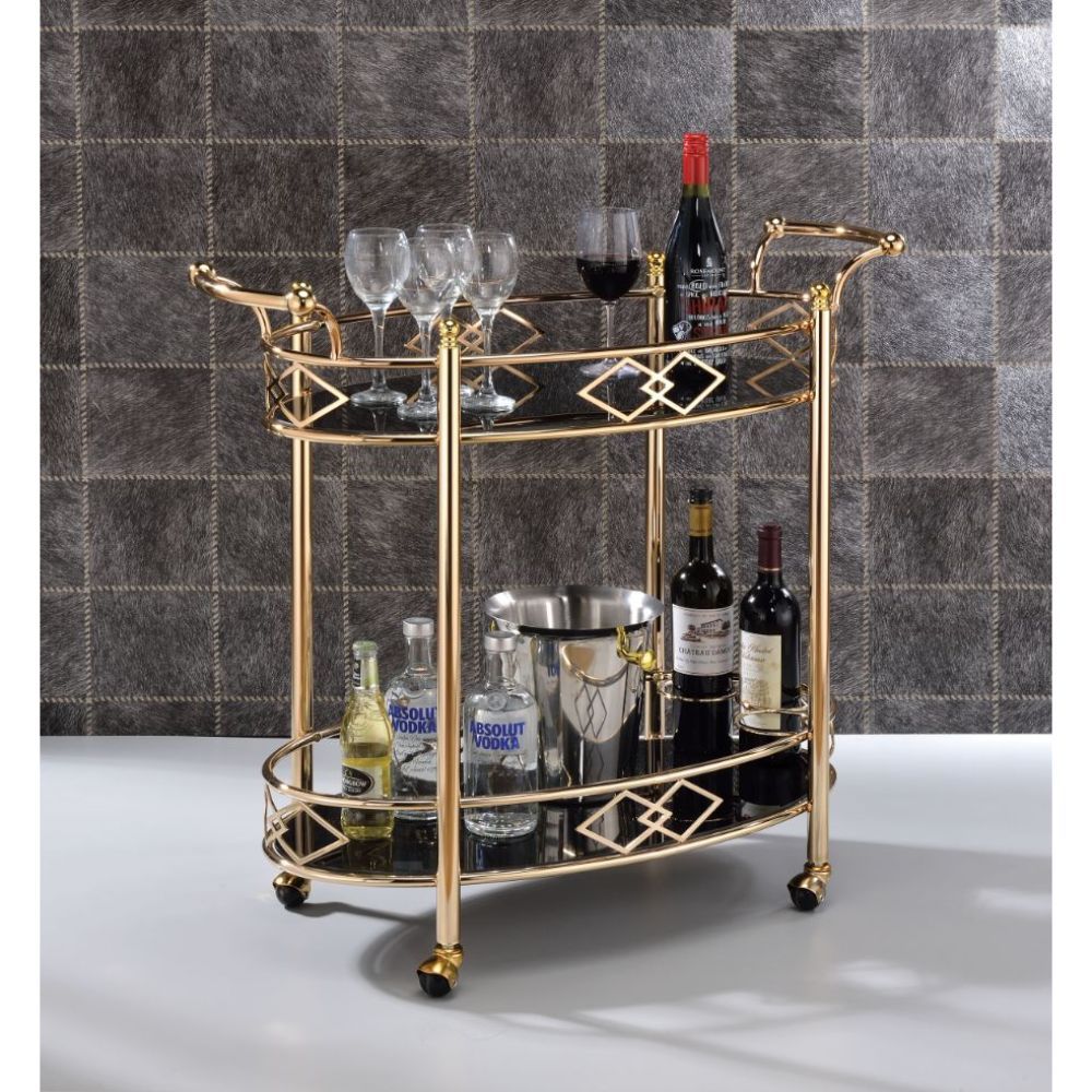 Add a bold statement to your kitchen or dining room with this Ottesen serving cart. With metal in a gold finish, and black tempered glass on both shelves. The caster wheels allow you to move from room to room effortlessly. Along with its excellent functio