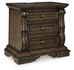 From its ornamental appliques to its large scale, this nightstand makes a bold statement. Spacious drawers store your bedtime essentials in stunning style. A hidden pull-out tray behind the bottom drawer puts your small valuables out of sight. The look is