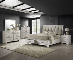 This bedroom set offers a sleek and stylish update to any space, featuring a white mist finish that commands attention while maintaining a sense of warmth and coziness. The bed stands as the stunning centerpiece, with its high, padded headboard upholstere