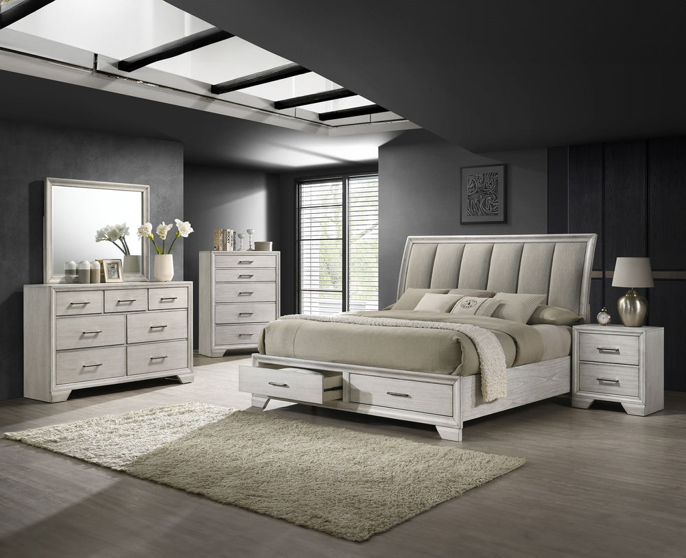 This bedroom set offers a sleek and stylish update to any space, featuring a white mist finish that commands attention while maintaining a sense of warmth and coziness. The bed stands as the stunning centerpiece, with its high, padded headboard upholstere