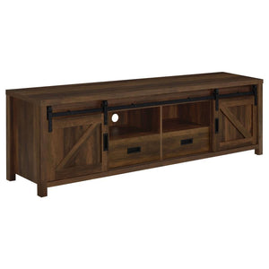 Wood-like finishes and country-inspired elements create this rustic style TV console. Keep entertainment consoles, a stereo and more tucked neatly within two open shelves toward the center. Disguised by sliding barn doors mounted on black hardware that le