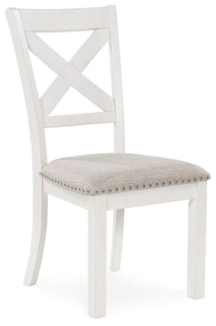 This dining chair is sure to impress come mealtime. With its antiqued white finish, classic country X-back and light gray upholstery with nailhead trim, modern farmhouse-style dining has never been so fashionable. All that-'s missing is you and your famil