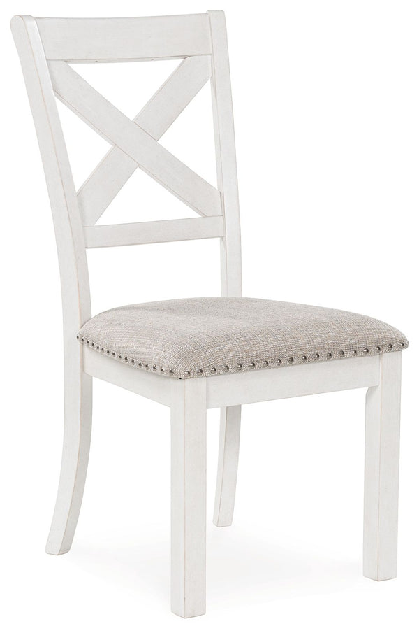 This dining chair is sure to impress come mealtime. With its antiqued white finish, classic country X-back and light gray upholstery with nailhead trim, modern farmhouse-style dining has never been so fashionable. All that-'s missing is you and your famil