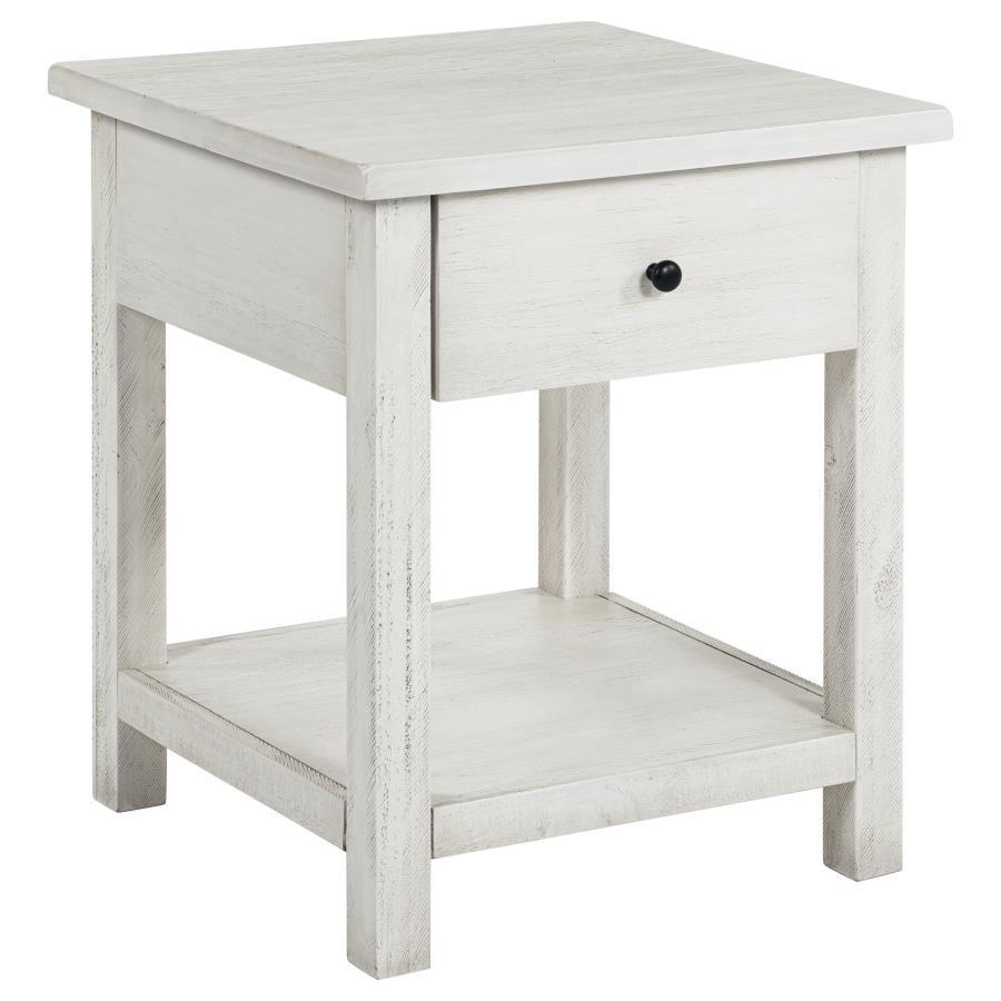 This rustic end table merges classic style with practical storage, making it a charming focal point in any living room. Built from pine wood and reinforced with engineered wood, its square silhouette highlights a subtle, timeworn aesthetic. An integrated 