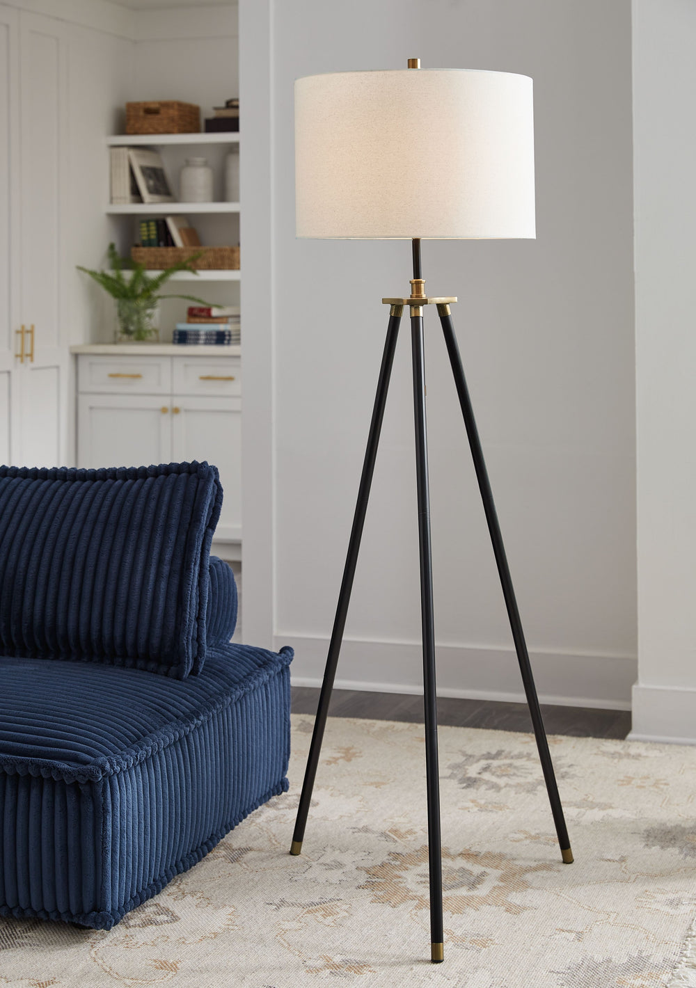 This floor lamp strikes a pose for casually cool style. A snappy tripod base and handsome finish make it all the more interesting. The adjustable height design makes it all the more functional. Tuck this lamp behind a chair or sofa as a reading lamp, or t
