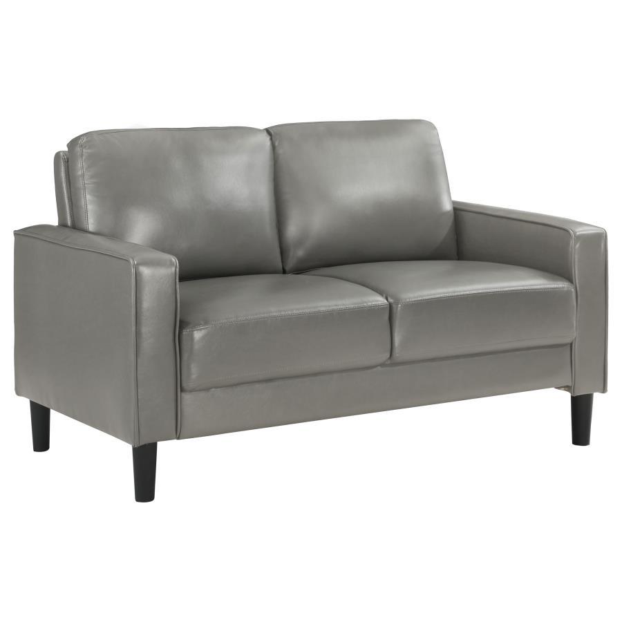 A compact profile makes this modern loveseat the perfect choice to add seating in a living room or den. Itâ€™s a structured silhouette complete with track arms. Faux leather upholstery is supple and smooth, offering contemporary style and sophistication t