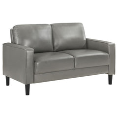 A compact profile makes this modern loveseat the perfect choice to add seating in a living room or den. Itâ€™s a structured silhouette complete with track arms. Faux leather upholstery is supple and smooth, offering contemporary style and sophistication t