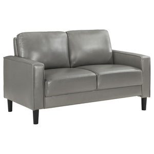 A compact profile makes this modern loveseat the perfect choice to add seating in a living room or den. Itâ€™s a structured silhouette complete with track arms. Faux leather upholstery is supple and smooth, offering contemporary style and sophistication t