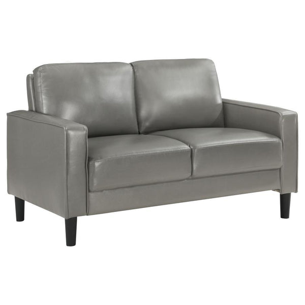 A compact profile makes this modern loveseat the perfect choice to add seating in a living room or den. Itâ€™s a structured silhouette complete with track arms. Faux leather upholstery is supple and smooth, offering contemporary style and sophistication t
