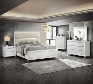 This bedroom set is a sophisticated fusion of modern design and luxurious comfort. Each piece boasts a bright white finish, accented with sleek mirrored trim that adds a touch of shine and refinement. The centerpiece is an opulent bed with an oversized he