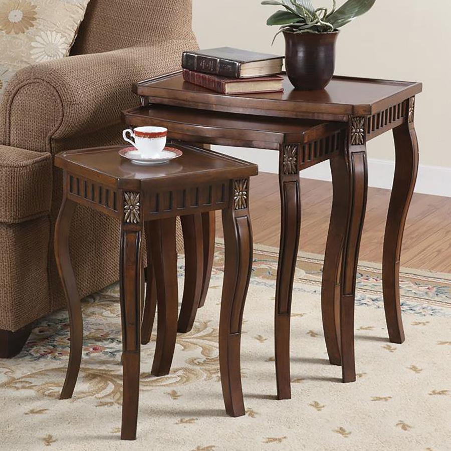 This three-piece nesting table set showcases an elegant design with beautiful detailing on the legs. The warm brown finish adds to its rich, traditional style, making it perfect for any living room space. The tables are crafted from durable engineered woo