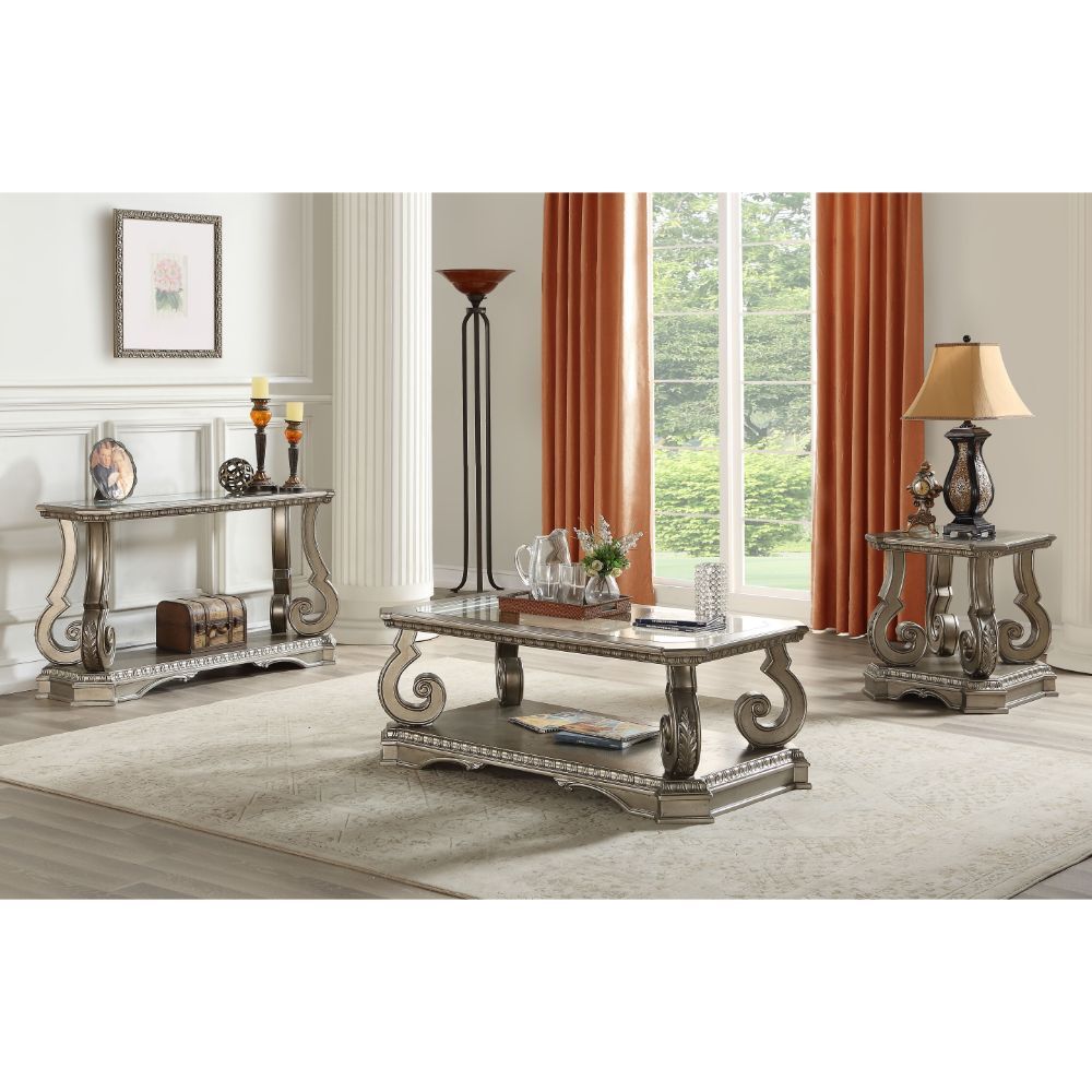 Entertain in style with the Northville Coffee Table. This classic rectangular occasional table features an Antique Silver and a tempered glass top. This distinctive cocktail is accented with wooden floral scrolled legs and a beveled glass insert and an op