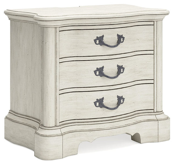 Add a touch of romance to your bedroom with this nightstand. Its antiqued white painted finish and serpentine-shaped silhouette are the definition of easy elegance. The nightstand-'s three spacious drawers accommodate bedside essentials, while an integrat