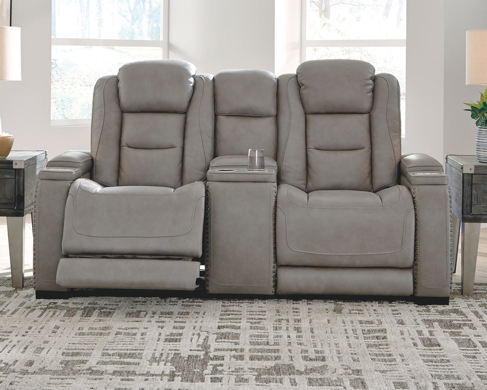 Reserved for him and made for her, this power reclining loveseat in gray delivers all the comfort and style you could ask for. Inspired by sports car interiors, the expertly matched leather and faux leather upholstery has a â€œperforated automotiveâ€ tre