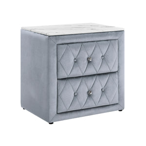This elegant nightstand brings a touch of luxury to any bedroom with its rich, velvety texture and diamond-patterned tufting. The soft, plush exterior is complemented by gleaming crystal-like drawer knobs, adding a hint of glamour. With two spacious drawe