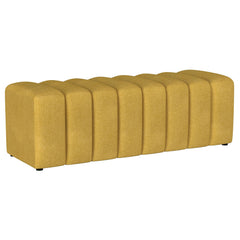 Introduce glam texture and dimension with a decorative upholstered bench. This modern creation features an undulating silhouette without arms or a back, offering sleek style and seating. Perfect for a sophisticated foyer or living room, it adds a pop of c