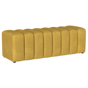Introduce glam texture and dimension with a decorative upholstered bench. This modern creation features an undulating silhouette without arms or a back, offering sleek style and seating. Perfect for a sophisticated foyer or living room, it adds a pop of c