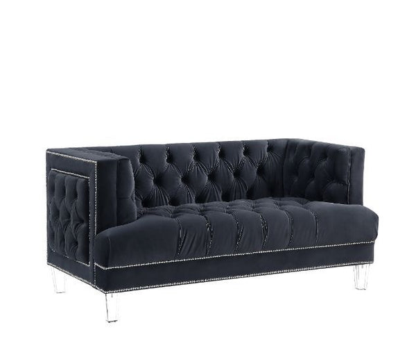Sophistication meets modern with the Ansario living room collection. The rich blue velvet adds character to any room. Showcasing a square back, high arms, and nail-head trim, feature button tufted accents. The acrylic legs give off a modern vibe to the pi