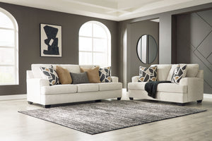 Embrace effortless elegance with this sofa and loveseat set. Its clean lines and curved details are right at home in contemporary settings. Stressed about styling? The neutral hue easily pairs with your existing color palette. From lounging alone to socia