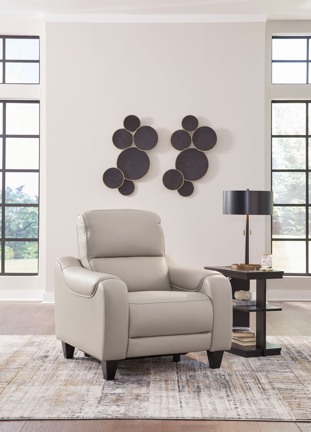 This power recliner puts a sleek twist on laid-back living. It satisfies your desire for comfort without being bulky in design, thanks to subtly incorporated one-touch reclining and adjustable headrests. With chic exposed legs and stunning stitching detai