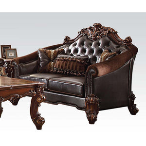 Tracing back to the classical Baroque era, expressed with intent and conviction, our new interpretation of Vendome II is donned. The Vendome II loveseat-'s two-toned brown faux leather and cherry upholstery is grand and classy with crystal like button tuf