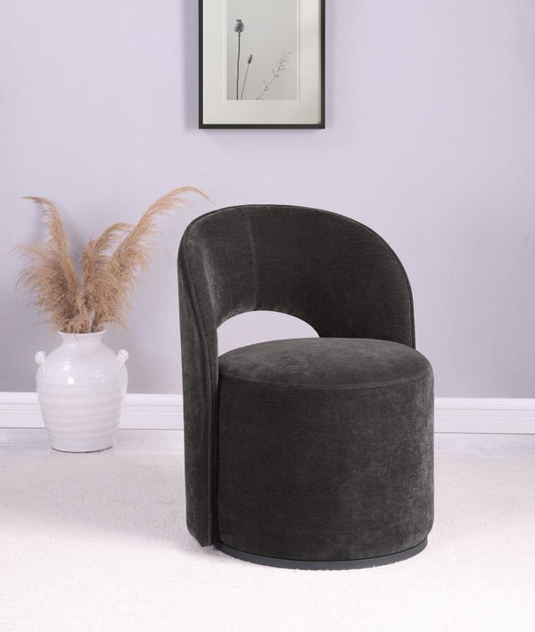  featuring luxurious velvet upholstery. Its curved silhouette and 360-degree rotation enhance versatile seating arrangements. Perfect for a living room corner or reading nook