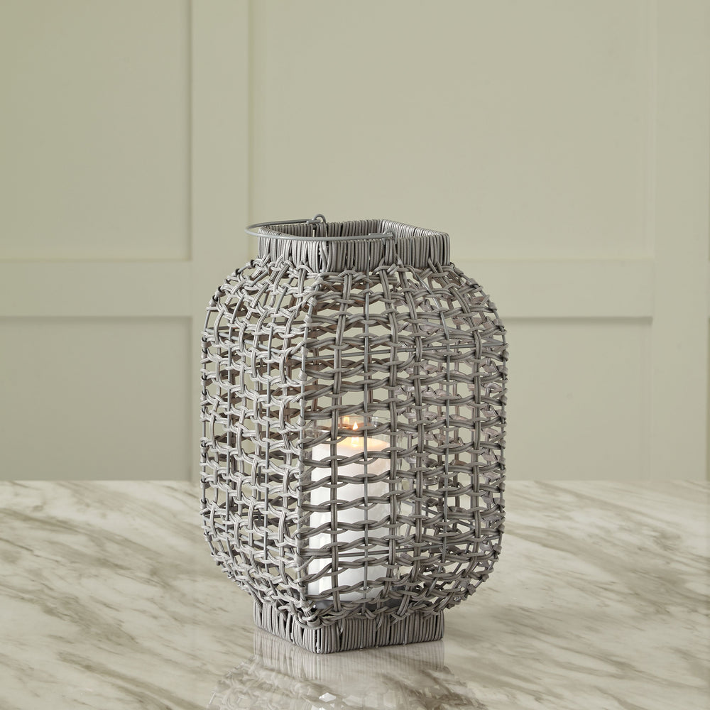 Complete the look of your restful retreat with this homey lantern. Its antiqued gray faux rattan filters the light of your candle (not included) to give a gentle glow to your space. When not in use, this chic indoor/outdoor piece rounds out your decor wit