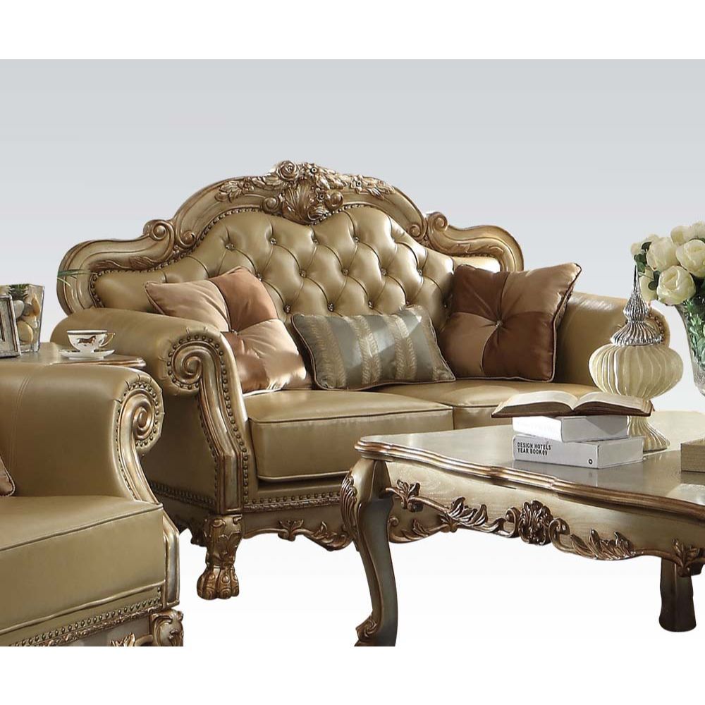 The Dresden gold patina and bone faux leather loveseat has a traditional feel, featuring decorative carvings, inlay veneer ball and claw feet and hand brushed gold accents. The seat and back have a faux leather button tufted cushion with Nailhead trim. Co