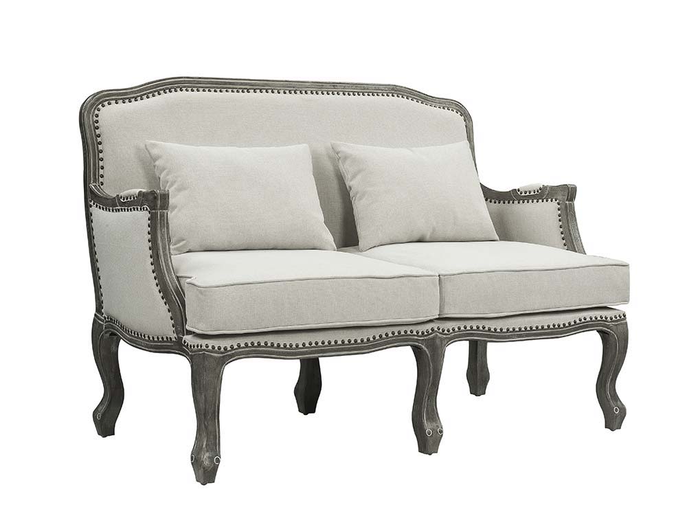 Finely crafted with superb carved details and a lovely natural finish, the Tania sofa flaunts a French cabriole silhouette that perches on graceful cabriole legs and showcases its antique-inspired profile. The nailhead trim accents give this piece a moder