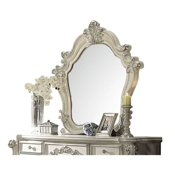 The Versailles mirror gives your bedroom all the grandeur of royal style. Presented in a stately bone white finish this mirror has a substantial silhouette and is adorned with such old-world details, carved medallions, and shaped moldings. This mirror is 