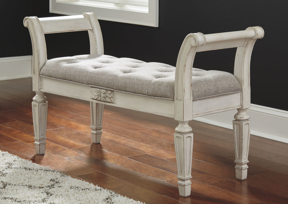 A classic to be cherished for years. This accent bench is a timeless treasure. Quality wood frame flaunts an antiqued white finish. Touches like the scrolled arms and floral applique give this piece so much character. Youâ€™ll love sitting on the cushiony