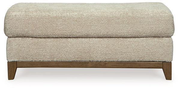  showcasing soft upholstery accented with a transitional wood trim. As refined as it i