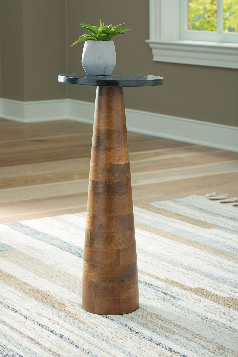 Blending the beauty of marble and wood, this accent table is eager to host your decorative accents or help keep relaxation essentials on hand. Its poised, slim form easily fits between a sofa and loveseat. Stunning in its simplicity, youâ€™ll love the ele