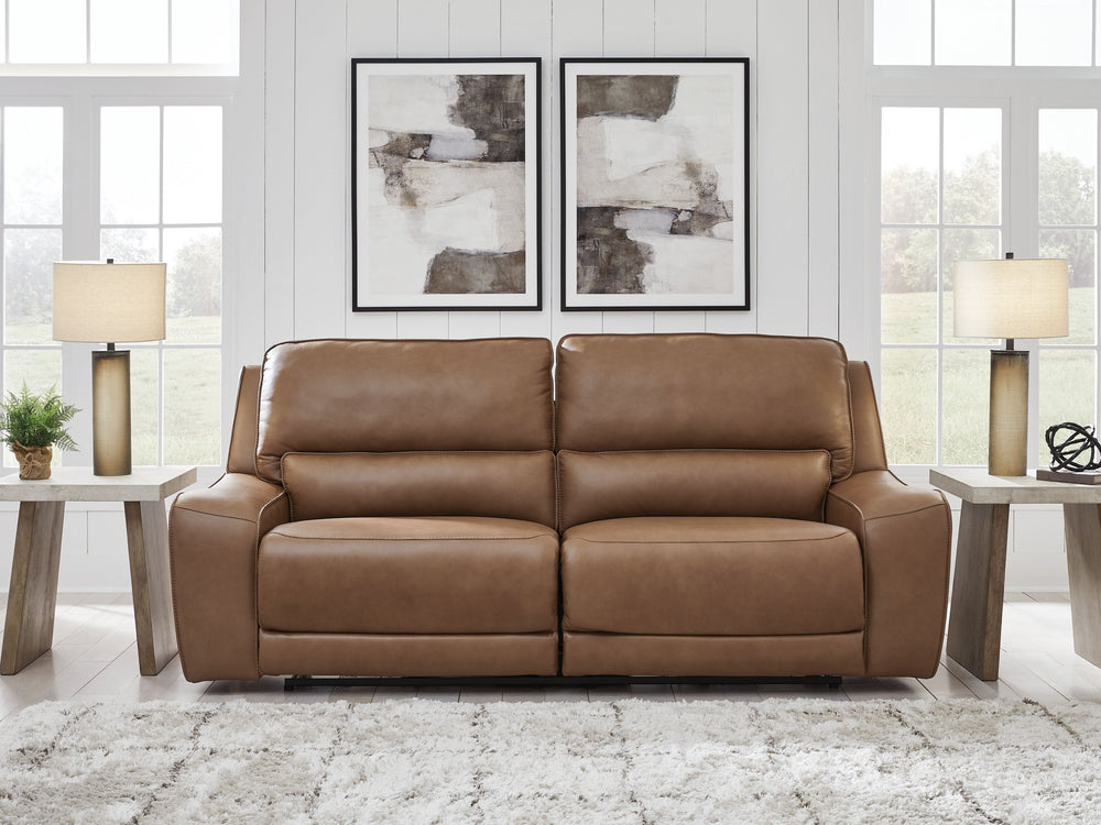Live and lounge luxuriously. This power reclining sofa brings an ultra-stylish flair to your homeâ€™s central hub. Its seating area is wrapped in top-grain leather in a rich caramel coloration, giving you a trend-right look made all the better with high-q