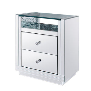 The Nysa End Table will give any room a touch of glamour. This contemporary nightstand is fully mirrored with a beveled edge and stunning glass top with a storage shelf surrounded by faux crystal inlay. Use this unique piece as the perfect accent for any 